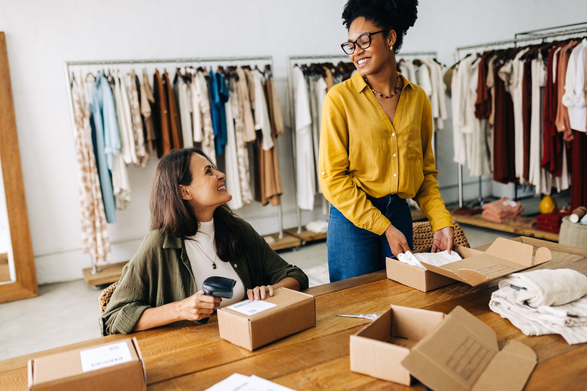 Dropshipping success: Female entrepreneurs fulfilling online orders for their clothing store