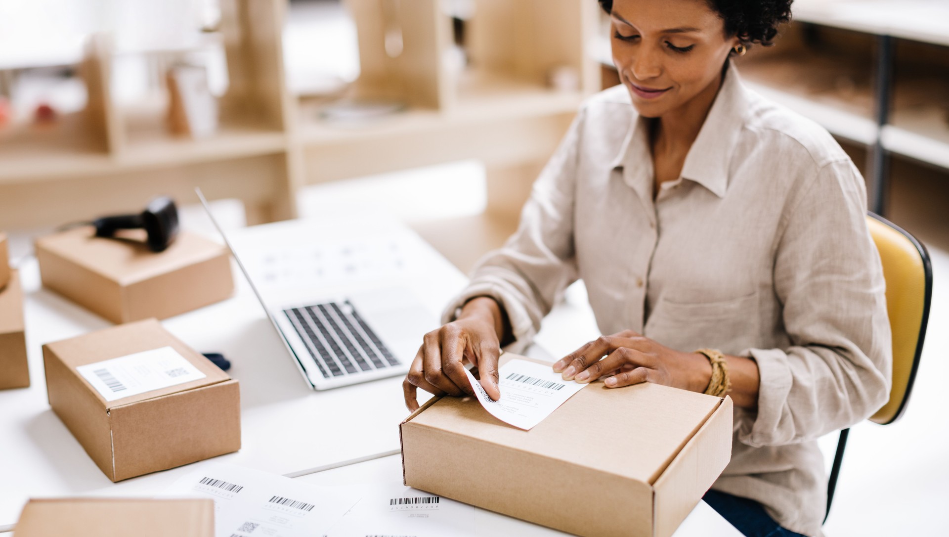 Female entrepreneur preparing an online order for shipping